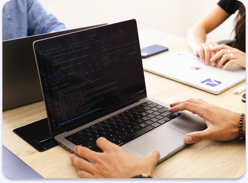 Developer working on a laptop during a kick off